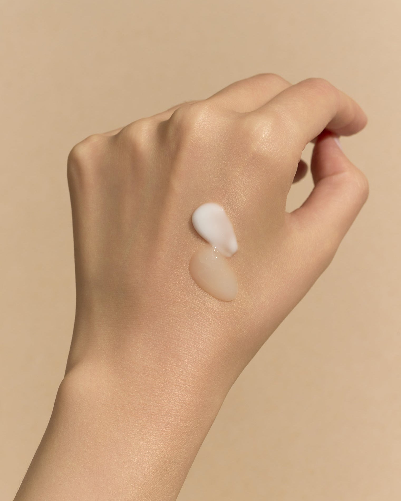 Hand with both a serum and cream smear