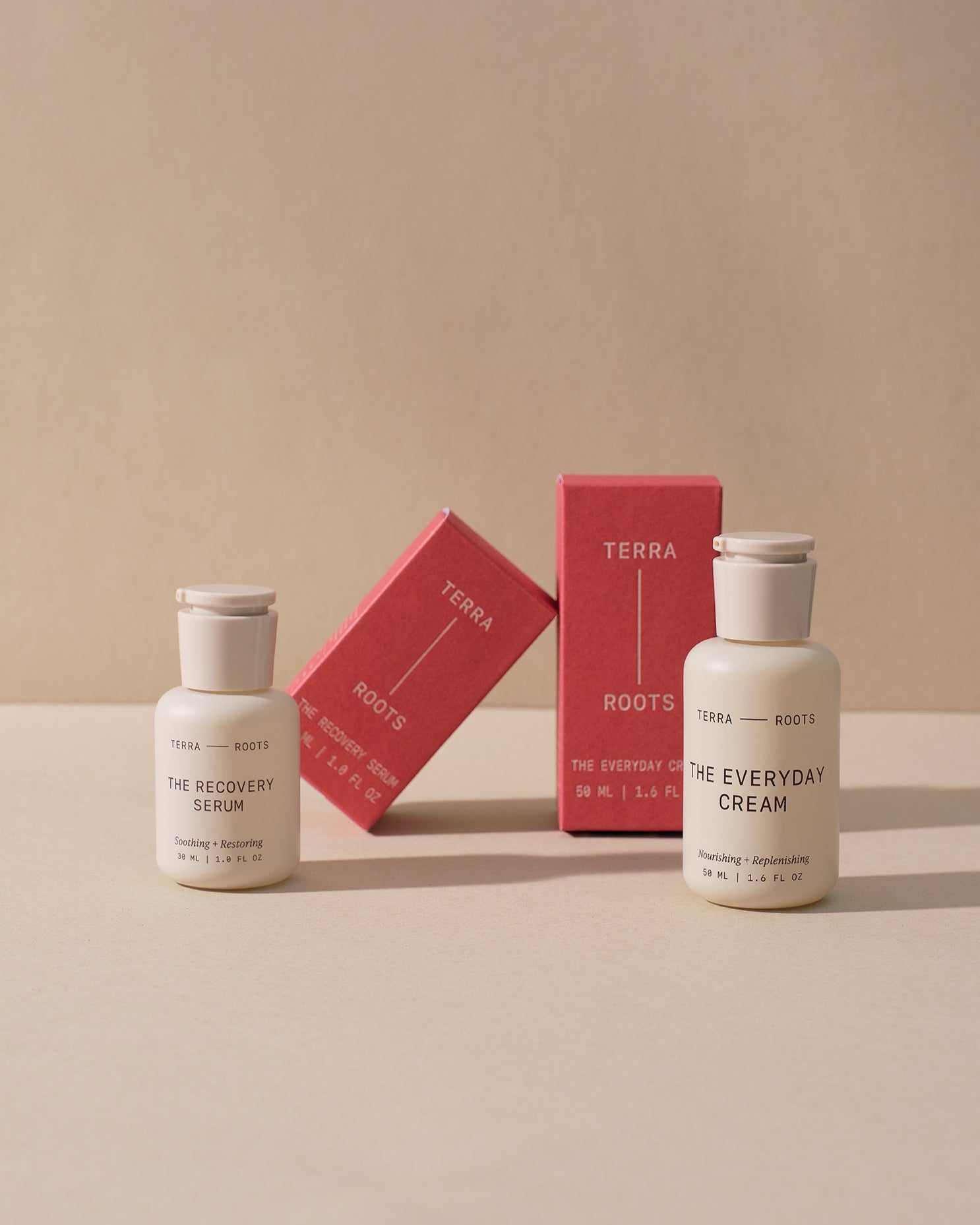 Terra Roots skincare products next to their orange boxes on a beige background