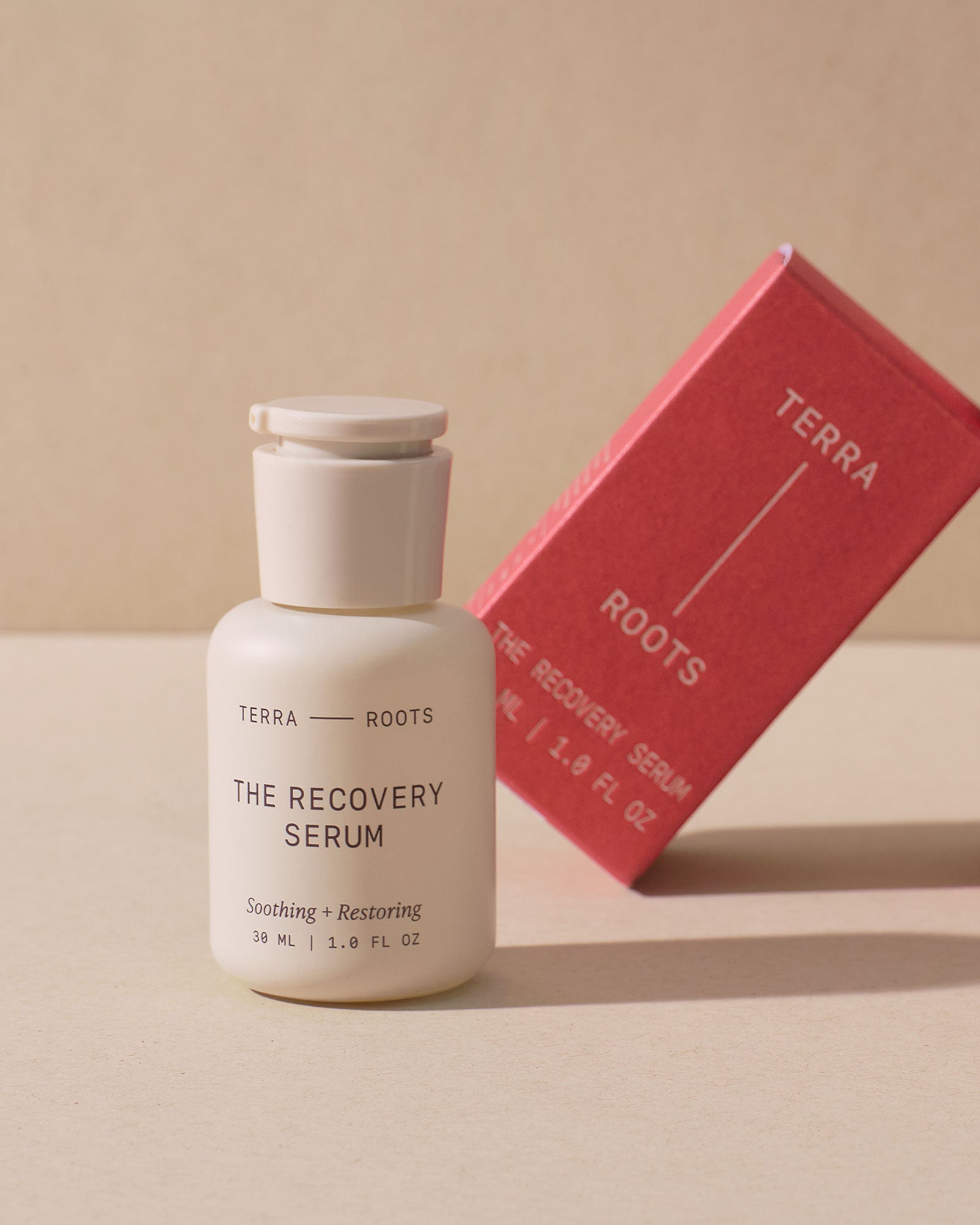 Terra Roots The Recovery Serum bottle with a red box on a beige background