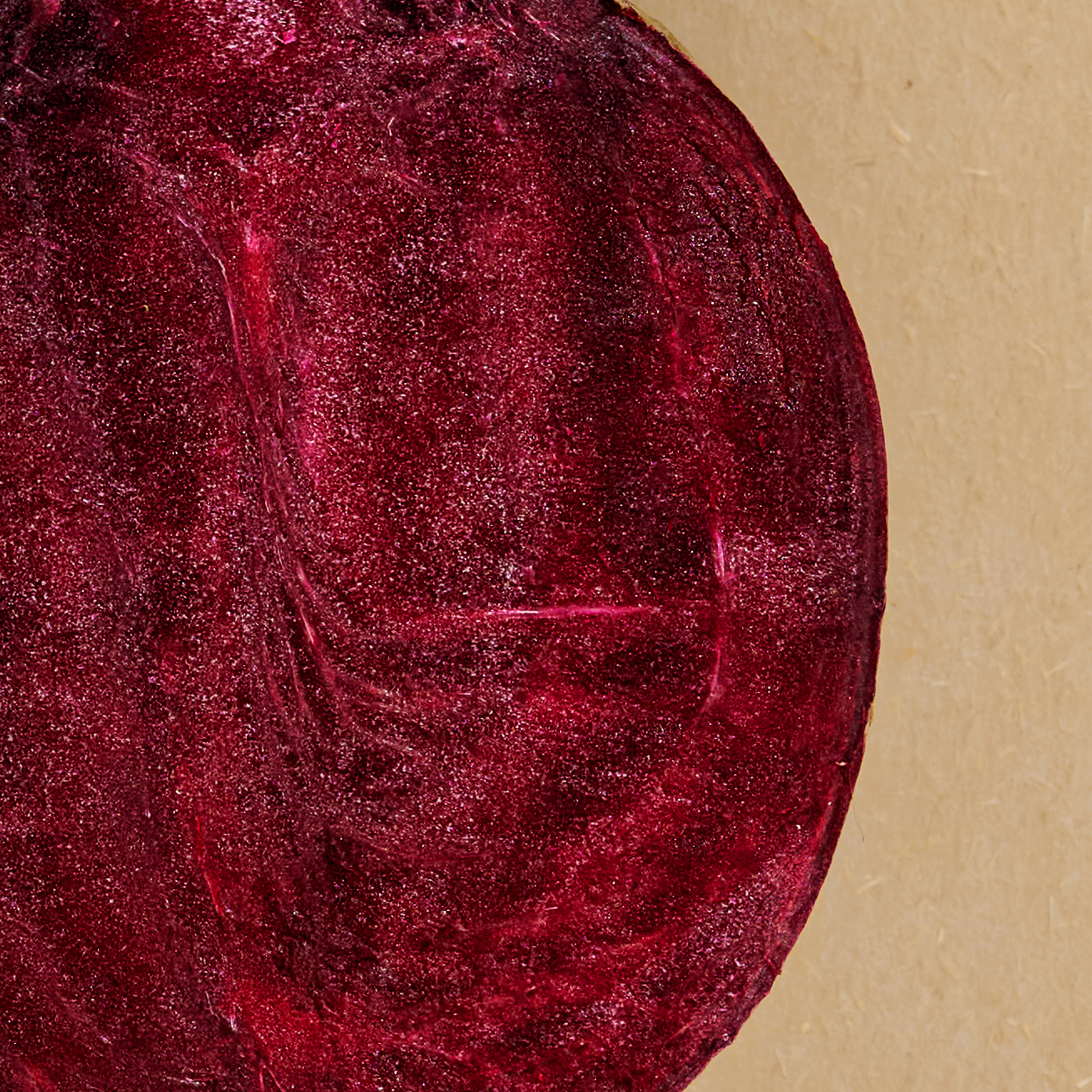 Close-up of a red beet on a beige background