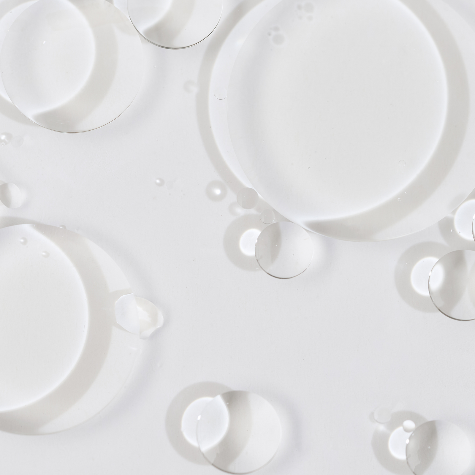 Close-up of bubbles from a clear liquid on a white background